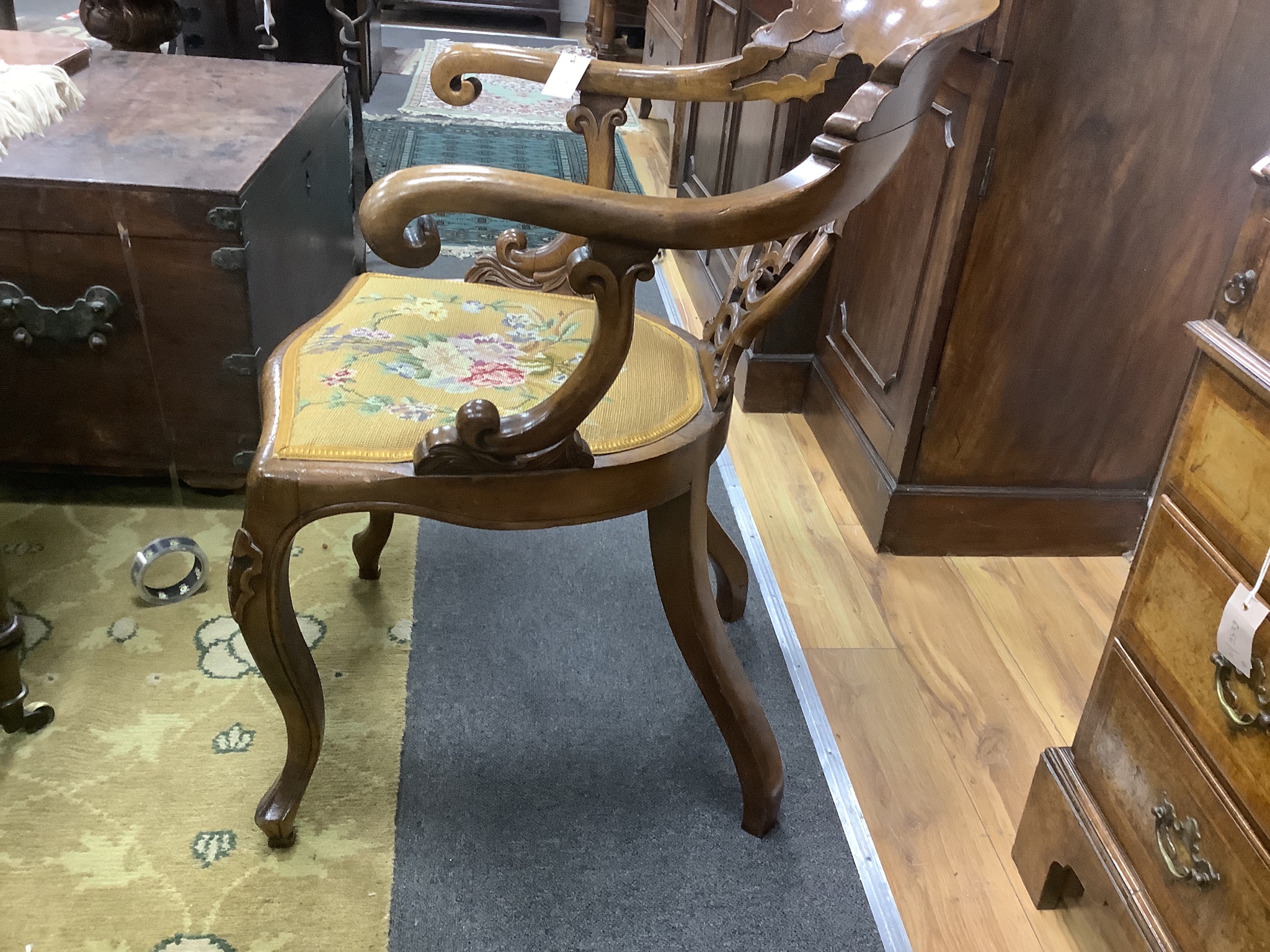 A Victorian carved walnut elbow chair, width 58cm, depth 48cm, height 90cm